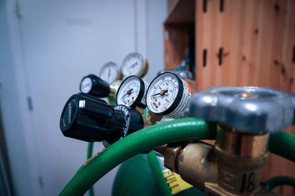 Détendeurs à deux manomètres montés sur des bouteilles de gaz, tuyau vert